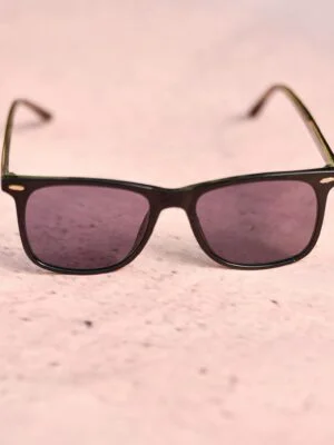 Trendy pink sunglasses displayed on a light pink textured surface for a fashionable look.