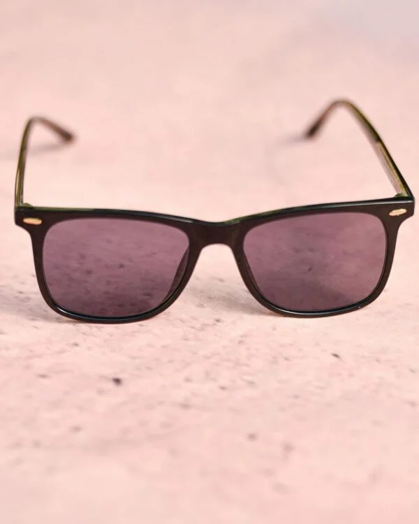Trendy pink sunglasses displayed on a light pink textured surface for a fashionable look.